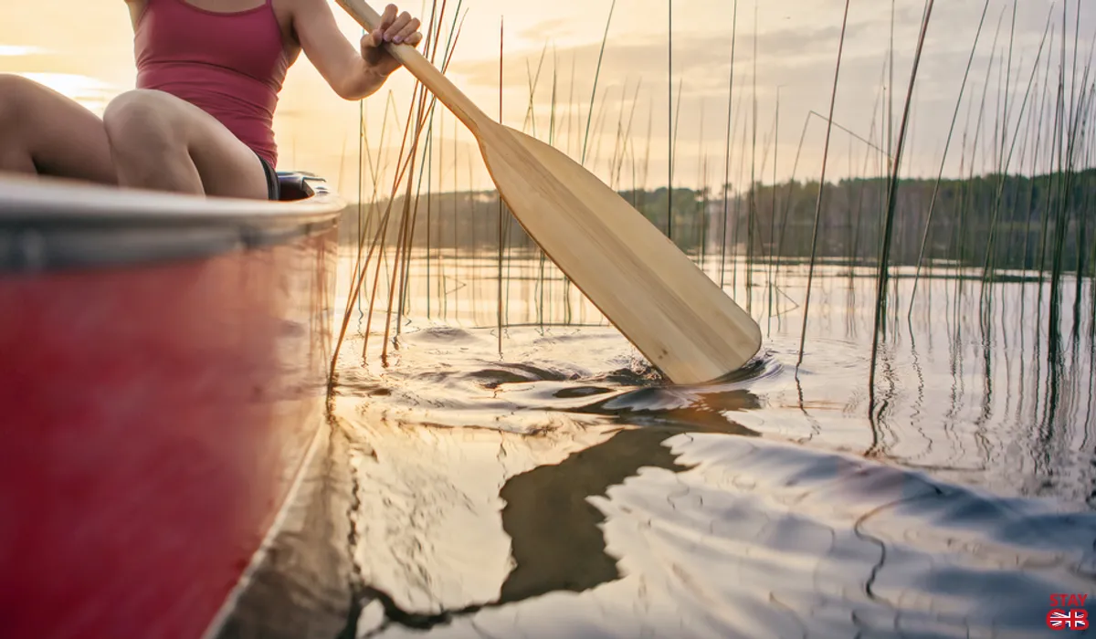 Woman in paddling a caadian canoe